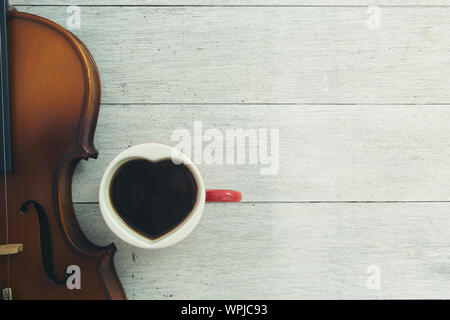 cup ofcoffee and violin on wooden Stock Photo