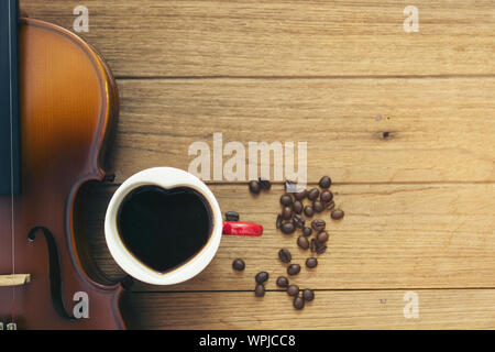 cup ofcoffee and violin on wooden Stock Photo