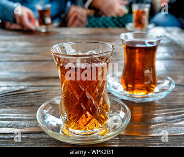 Tea in Azerbaijani traditional armudu (pear-shaped) glass on a wooden table Stock Photo