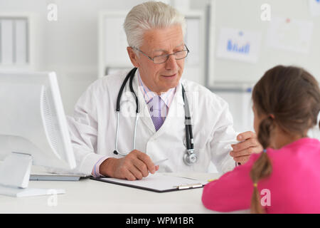 Portrait of happy young family visiting doctor Stock Photo