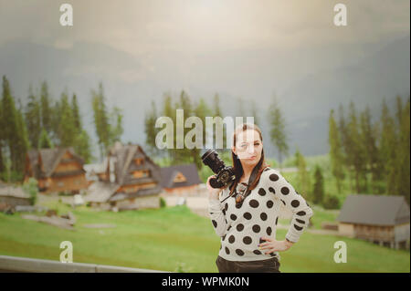 Woman photographer takes pictures in mountain in the summer Stock Photo