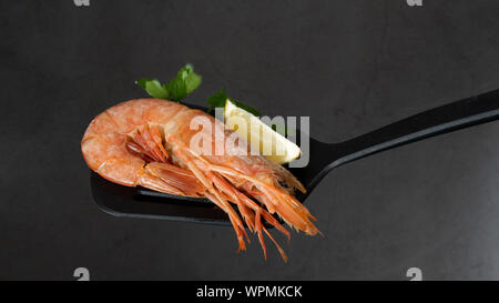 Fine selection of jumbo shrimps for dinner on stone plate. Stock Photo