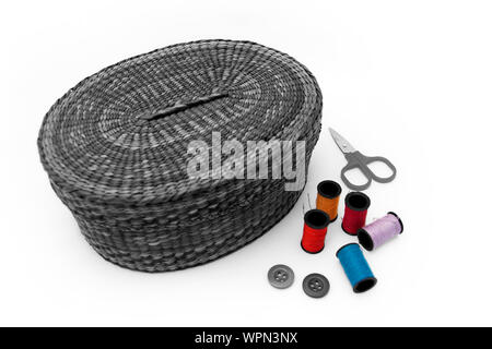 Sewing basket, scissors, bobbins, white background Stock Photo