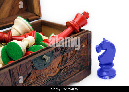 Chess pieces in a wooden box, white background Stock Photo