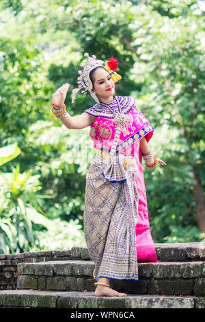 Asian woman wearing typical, traditional Thai Dress. It is literally means 'Thai outfit', National costume. Stock Photo