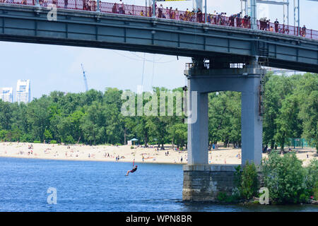 Kiev, Kyiv: bungee jumping, river Dnipro (Dnieper), Parkovy (Pedestrian) Bridge to Trukhaniv Island in , Kyiv, Ukraine Stock Photo