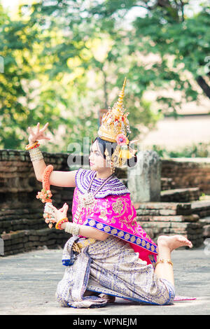 Asian woman wearing typical, traditional Thai Dress. It is literally means 'Thai outfit', National costume. Stock Photo
