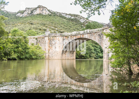 Reflection of a stone bridge over a river Stock Photo