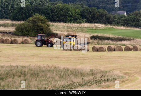 Gathering hay bales in Yorkshire, England. Stock Photo