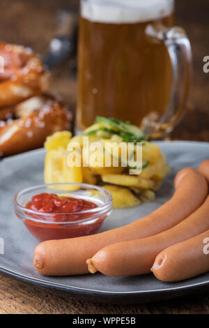 closeup of frankfurter sausages on rustic wood Stock Photo