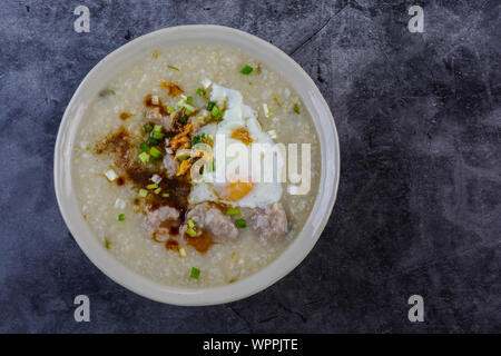 Congee, Rice porridge with minced pork, boiled egg, great for breakfast. Stock Photo