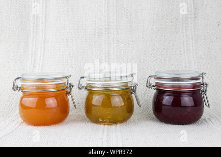 Composition of jars full of delicious sweet jam, healthy fruit marmalade, horizontal Stock Photo