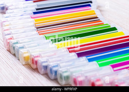 Multi-colored markers on a white wooden chtol, top view, place for text Stock Photo