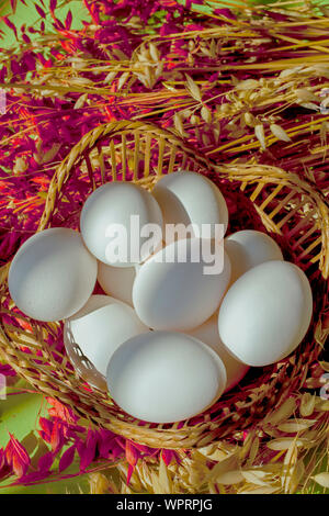 white eggs in basket vertical with copy space Stock Photo