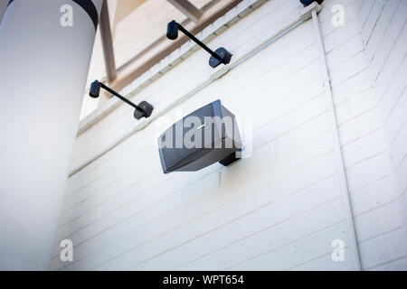 Los Angeles, California, United States - 02-18-2019: A view of a Bose brand speaker mounted on a building exterior wall. Stock Photo