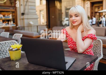 Young woman having italian breakfast with croissant and coffee a Stock Photo