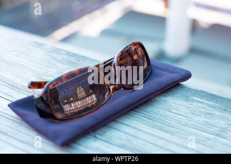 A view of the interior courtyard of the Castle Hotel Auf Schoenburg reflected in a pair of sunglasses, Oberwesel, Germany Stock Photo