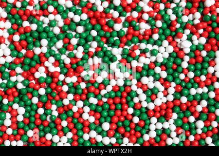 Abstract Christmas background of red, white and green little sugar balls Stock Photo