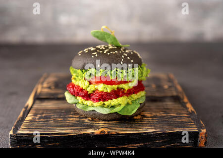 Vegan black burger with avocado and beet patty Stock Photo