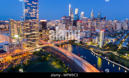 The city pumps out vibrant colorful light along the river in Philadelphia USA Stock Photo