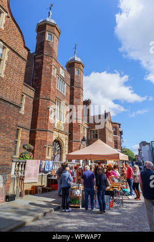 Guildford Antique & Brocante Street Market stall by the iconic Abbot's Hospital almshouse in High Street, central Guildford, Surrey, southeast England Stock Photo