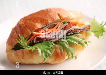 Sandwich with roast beef ham closeup isolated on white background Stock Photo