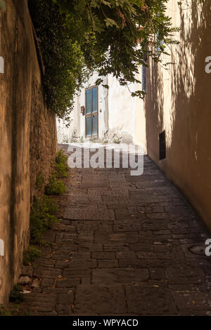 Doorway on narrow, winding, hilly street, Florence, Italy Stock Photo