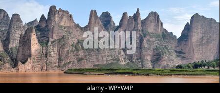 Liujiaxia Dam the picturesque place near the Bingling Cave with great rock formations along the Yellow River, Gansu province, China. Stock Photo