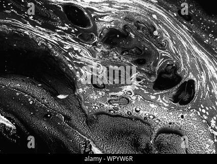 Abstract ink background. Marble style. Black paint stroke texture on white paper. Wallpaper for web and game design. Grunge mud art. Macro image of pe Stock Photo