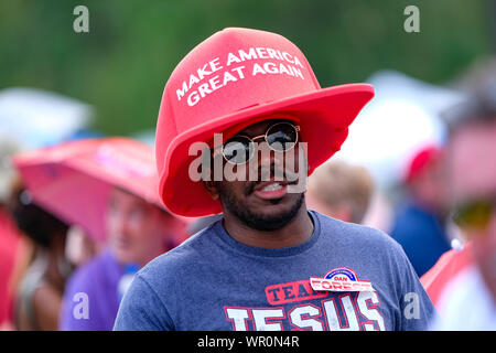 Fayetteville, United States. 09th Sep, 2019. Supporter with a pro Trump hat awaits President Trump during the MAGA rally in Fayetteville. Credit: SOPA Images Limited/Alamy Live News Stock Photo