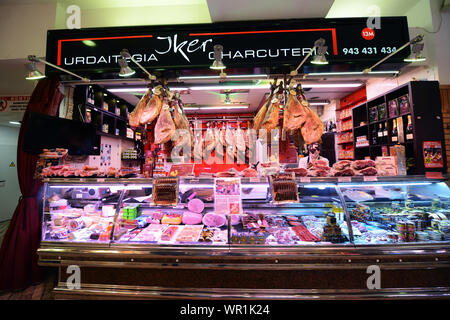 A traditional Basque cured & fresh meat shop at the Mercado de la Bretxa in San Sebastian, Spain. Stock Photo