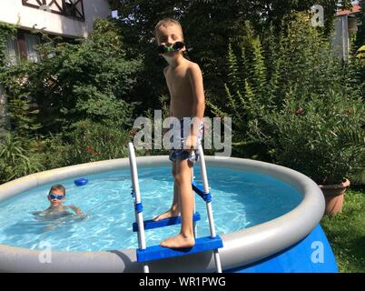 Family At Wading Pool In Yard Stock Photo 256202500 Alamy