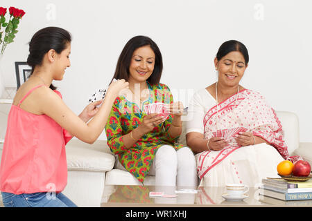 Family playing cards at home Stock Photo