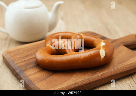 pretzel German bread on wood plate closeup isolated on table Stock Photo