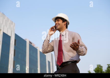 Architect talking on mobile phone Stock Photo