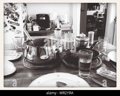 Utensils And Plates With Glasses On Table