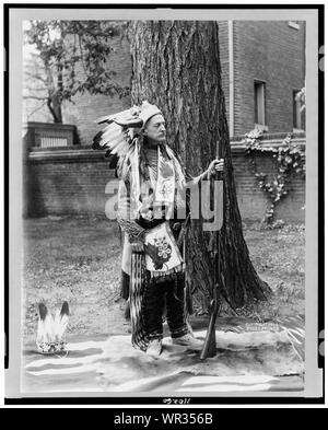 Matthew Stanley Quay, full-length portrait, standing, facing right, dressed in Indian costume, holding rifle Stock Photo