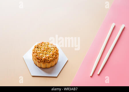 Flat lay of Chinese Festival dessert, Mid Autumn Festival Moon cake on colorful background with chopsticks. Top view, copy space, mockup, overhead Stock Photo