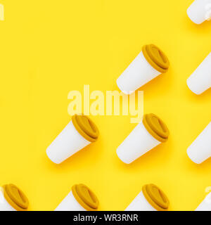 White bamboo coffee to go cup with a yellow rubber lid on a yellow background Stock Photo