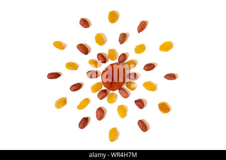 Pattern of Nuts - yellow raisins, dried apricots and peeled peanuts on a white background in the form of a circle. Concepts about decoration, healthy Stock Photo