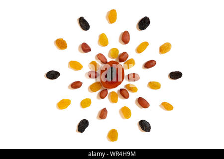 Pattern of Nuts - yello, brown raisins, dried apricots and peeled peanuts on a white background in the form of a circle. Concepts about decoration, he Stock Photo