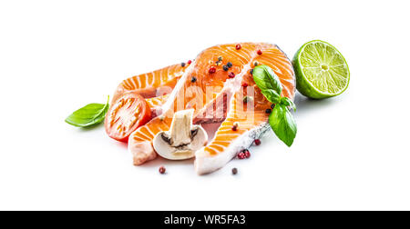 Salmon raw steaks basil tomato mushroom lime and spices isolated on white Stock Photo