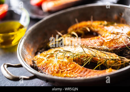 Salmon roasted steaks rosemary sal pepper olive oil - Close-up Stock Photo