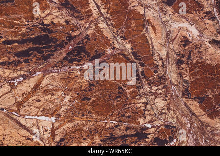 Texture of brown marble, colorful stone background. Grunge rock wall. Abstract natural modern pattern for design. Granite slab surface. Quartz tile. Stock Photo