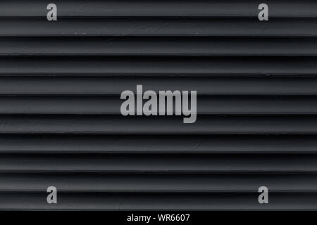 Abstract pattern of lines. Texture of black corrugated metallic surface. Dark ribbed background with stripes, straight lines. Modern pattern of gray m Stock Photo