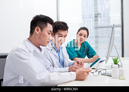 Healthcare people group. Professional doctor working in hospital office or clinic with other doctors, nurse and surgeon Stock Photo