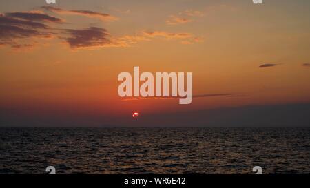 The sun sets over Dolphin Bay on the Greek Island of Kos Stock Photo