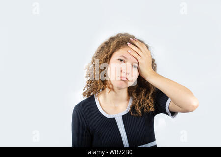 Young teenager girl suffering from depression having nervous breakdown holding her head looking to camera. Teenager problems, feeling bad,  psychologi Stock Photo