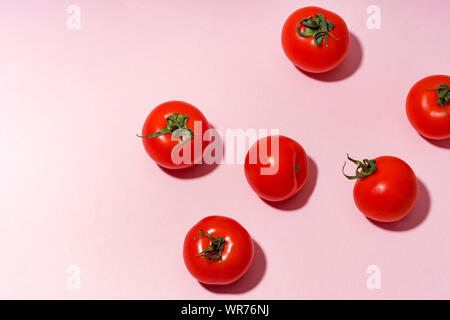 Pattern with cherry tomatoes on pink background Stock Photo