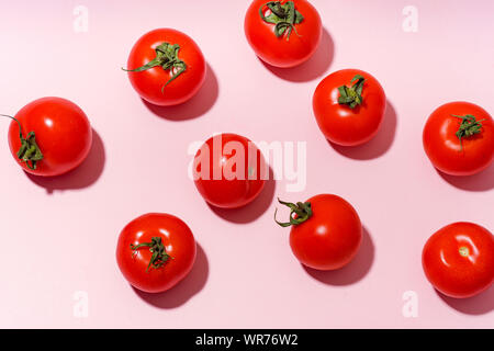 Pattern with cherry tomatoes on pink background Stock Photo